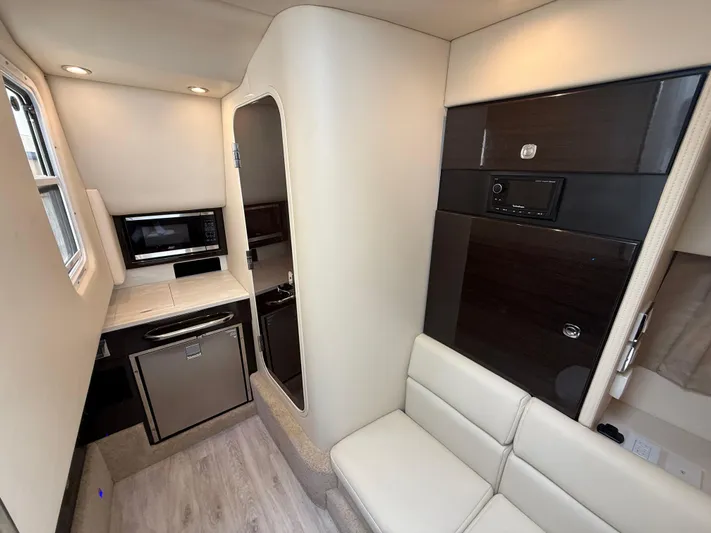  Yacht Photos Pics 2024 Formula 350 Crossover Bowrider interior with kitchenette and seating area.