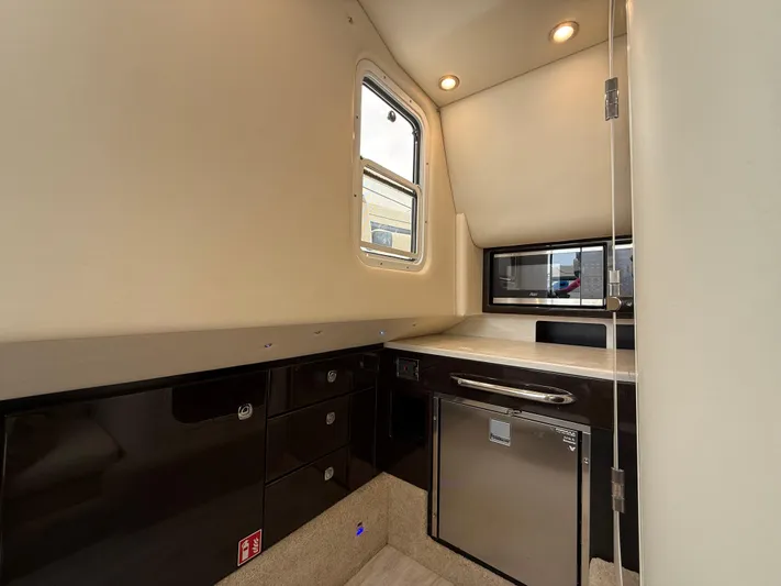  Yacht Photos Pics 2024 Formula 350 Crossover Bowrider interior with modern kitchenette and sleek cabinetry.