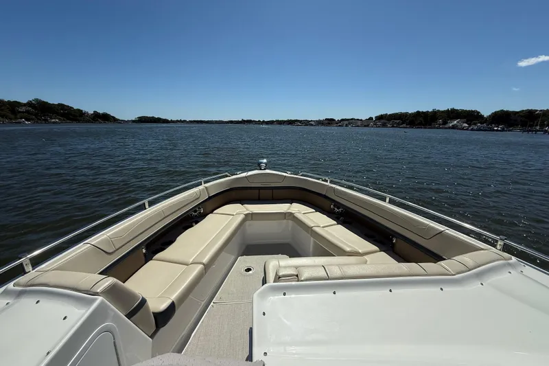  Yacht Photos Pics 2024 Formula 350 Crossover Bowrider on calm water, showcasing spacious seating and sleek design.