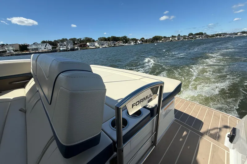  Yacht Photos Pics 2024 Formula 350 Crossover Bowrider cruising on a sunny day, showcasing luxury seating.