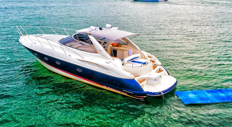  Yacht Photos Pics 2001 Sunseeker 44 Camargue yacht on clear water, featuring sleek design and spacious deck.