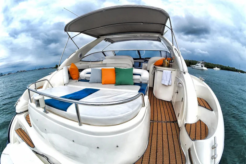  Yacht Photos Pics Sunseeker 44 Camargue 2001 yacht with spacious deck and colorful cushions on the water.