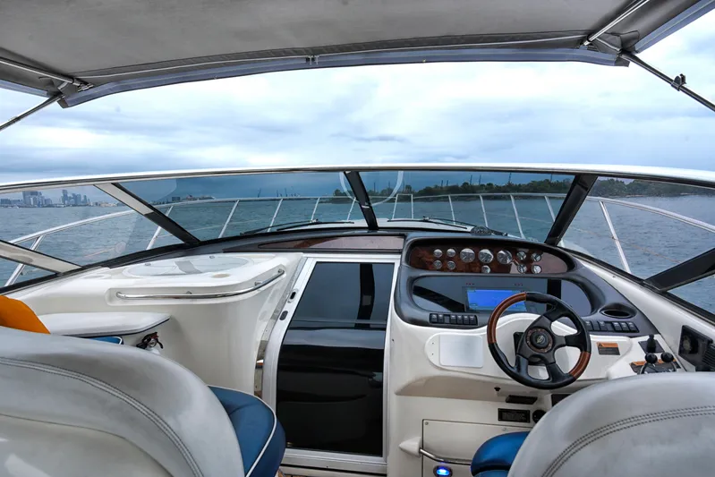  Yacht Photos Pics Interior view of 2001 Sunseeker 44 Camargue yacht cockpit, featuring steering wheel and dashboard.