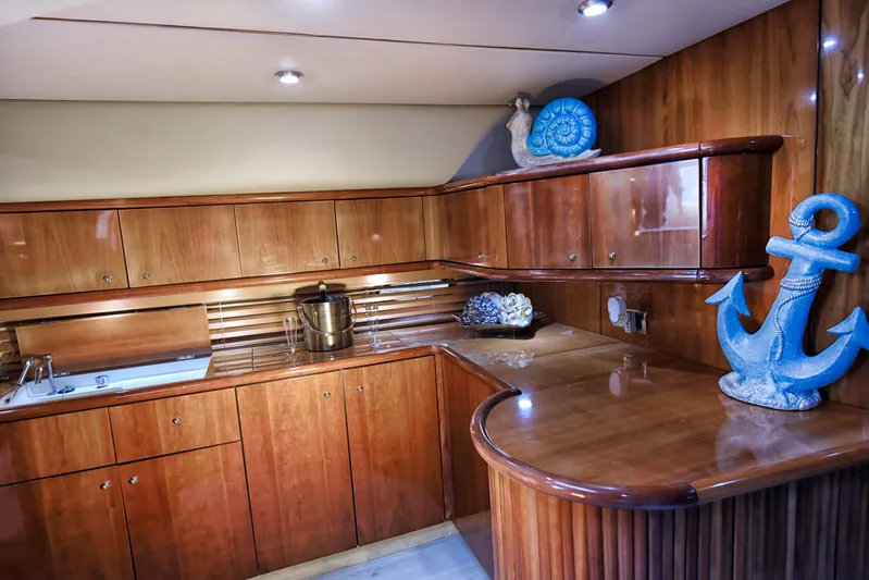  Yacht Photos Pics Luxurious wooden interior of 2001 Sunseeker 44 Camargue yacht kitchen with nautical decor.