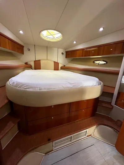  Yacht Photos Pics Luxurious cabin interior of 2001 Sunseeker 44 Camargue yacht with cozy bed and wood accents.