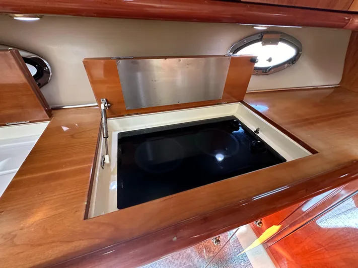  Yacht Photos Pics Sunseeker 44 Camargue 2001 yacht interior with sleek wooden cabinetry and modern stovetop.