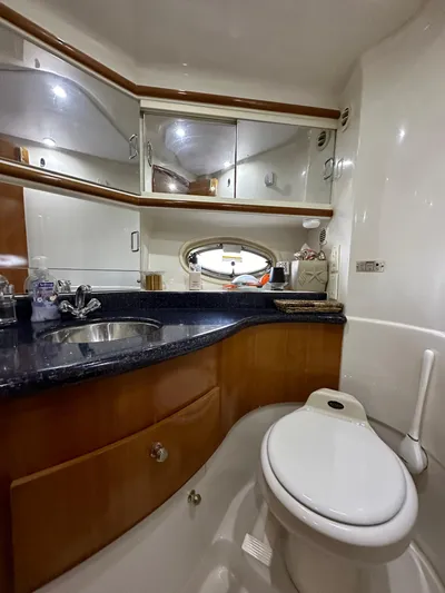  Yacht Photos Pics Luxurious bathroom in 2001 Sunseeker 44 Camargue yacht with modern fixtures and wood accents.