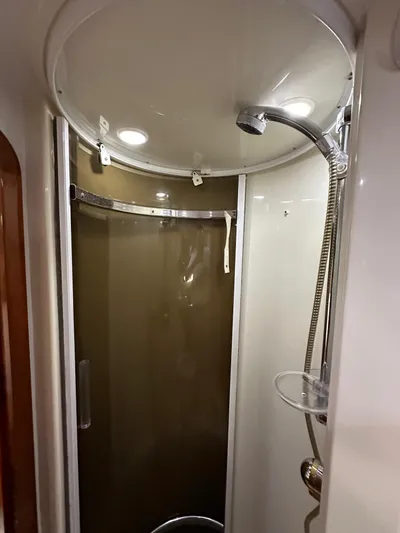  Yacht Photos Pics Shower area in 2001 Sunseeker 44 Camargue yacht, featuring modern fixtures and curved glass door.