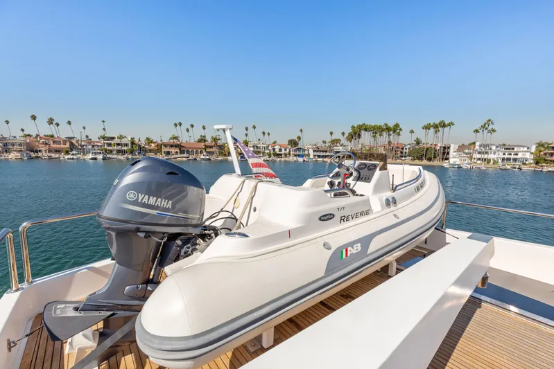 Reverie Yacht Photos Pics A 2005 Custom boat with Yamaha motor docked by waterfront homes.