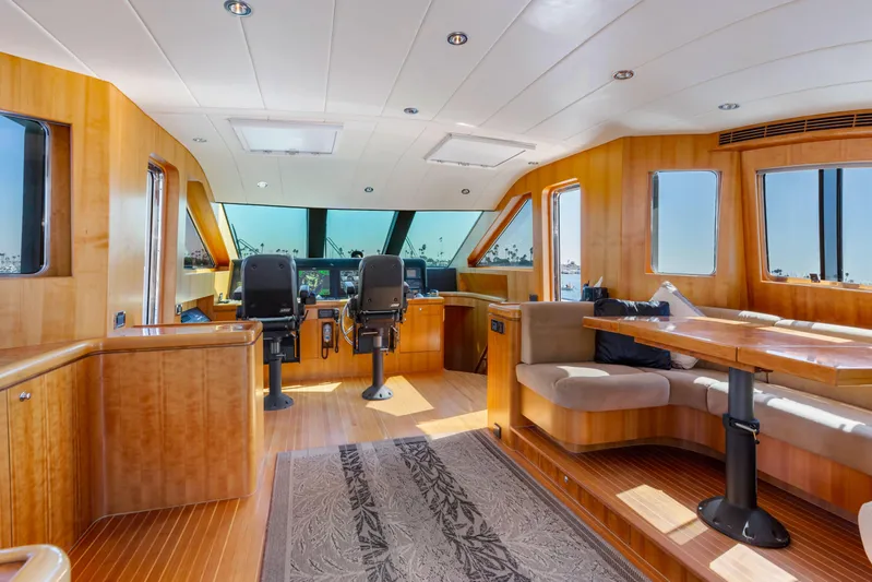Reverie Yacht Photos Pics Luxurious 2005 custom yacht interior with wood paneling and modern seating area.