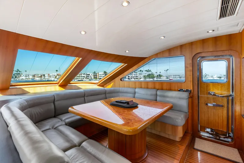 Reverie Yacht Photos Pics Luxurious yacht interior with leather seating, wooden table, and panoramic windows, 2005 Custom model.