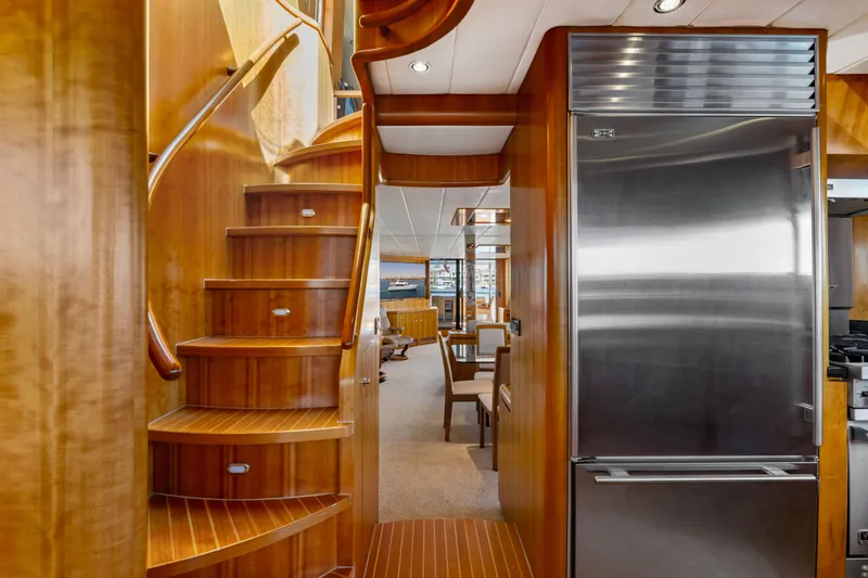 Reverie Yacht Photos Pics Luxurious yacht interior with wooden staircase and modern stainless steel refrigerator, 2005 Custom model.