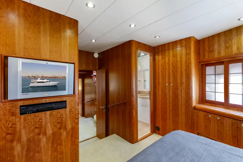 Reverie Yacht Photos Pics Luxurious yacht interior with wood paneling, TV, and bathroom access, 2005 Custom model.