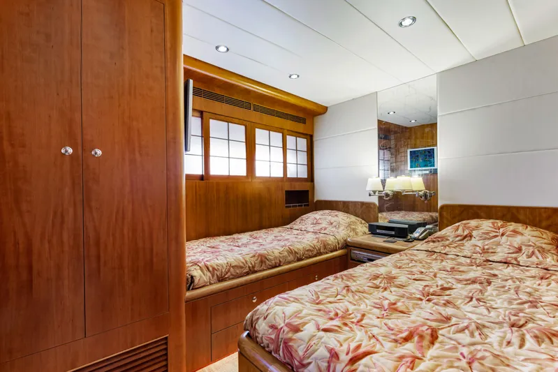 Reverie Yacht Photos Pics Luxurious yacht bedroom with twin beds, wooden cabinetry, and elegant lighting, 2005 Custom model.