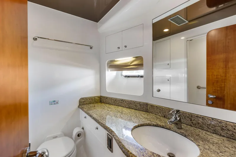 Reverie Yacht Photos Pics Modern bathroom with granite countertop, sink, and mirror in a 2005 Custom model.