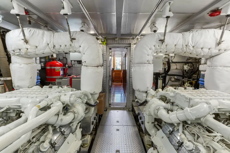 Reverie Yacht Photos Pics Engine room of a 2005 C Custom model, featuring dual engines and safety equipment.