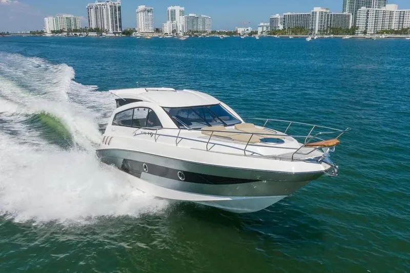  Yacht Photos Pics 2025 Hanover 375 yacht cruising on blue ocean near city skyline.