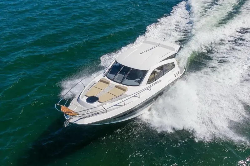  Yacht Photos Pics 2025 Hanover 375 yacht cruising on open water, creating a dynamic wake.