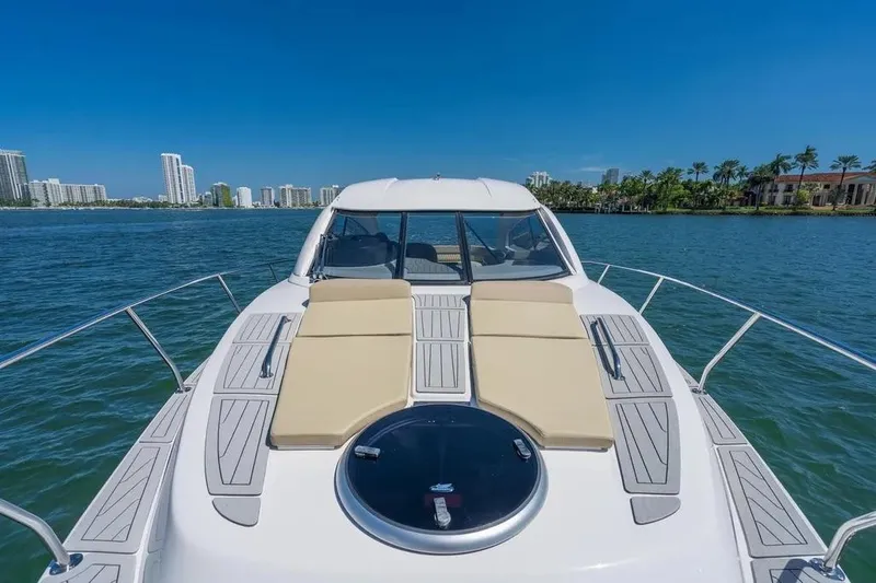  Yacht Photos Pics Luxury Hanover 375 yacht cruising on a sunny day, city skyline in the background.