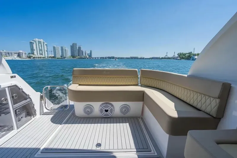  Yacht Photos Pics Luxurious seating on a 2025 Hanover 375 yacht with city skyline and ocean view.