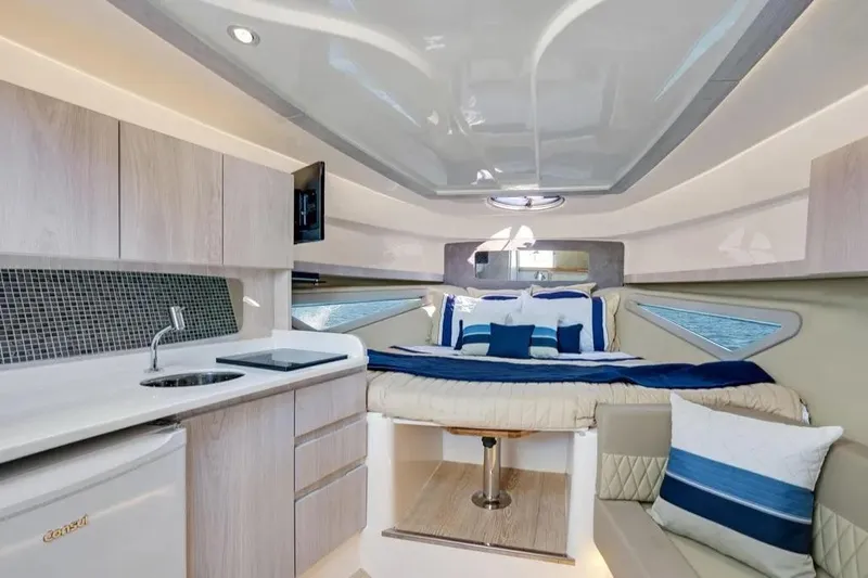  Yacht Photos Pics Luxurious interior of 2025 Hanover 375 yacht with modern kitchen and cozy sleeping area.