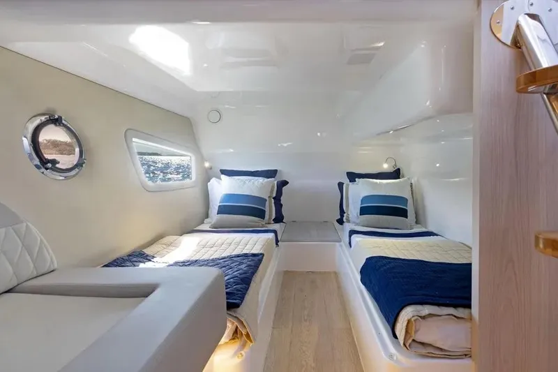 Yacht Photos Pics Luxurious cabin interior of 2025 Hanover 375 yacht with twin beds and nautical decor.