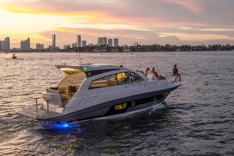  Yacht Photos Pics 2025 Hanover 375 yacht cruising at sunset near city skyline.