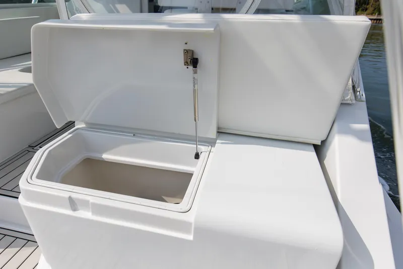 2017 Cummins 540s And Major Re-fit Throughout Yacht Photos Pics Open storage compartment on 1995 Cabo 35 Express boat, showcasing interior space.