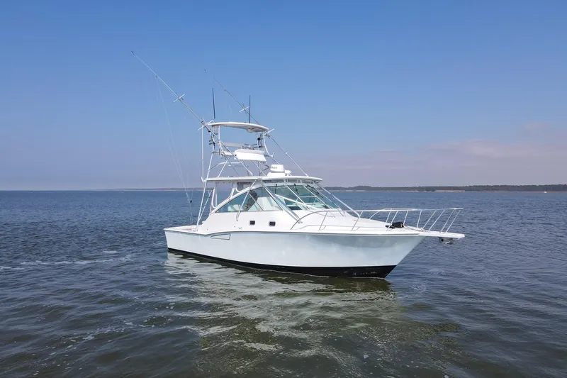 2017 Cummins 540s And Major Re-fit Throughout Yacht Photos Pics 1995 Cabo 35 Express boat on calm water under clear blue sky.