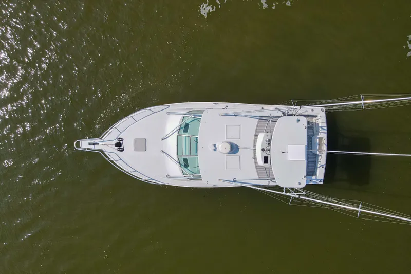 2017 Cummins 540s And Major Re-fit Throughout Yacht Photos Pics Aerial view of 1995 Cabo 35 Express boat on calm water.