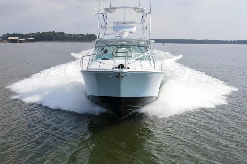 2017 Cummins 540s And Major Re-fit Throughout Yacht Photos Pics 1995 Cabo 35 Express boat cruising on open water, creating a dynamic wake.