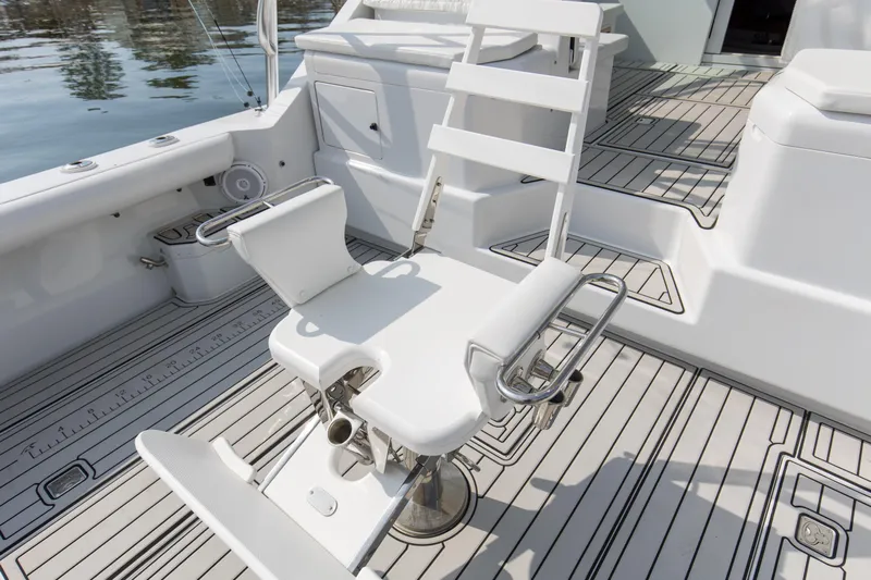 2017 Cummins 540s And Major Re-fit Throughout Yacht Photos Pics Fishing chair on 1995 Cabo 35 Express boat deck, featuring sleek white design.