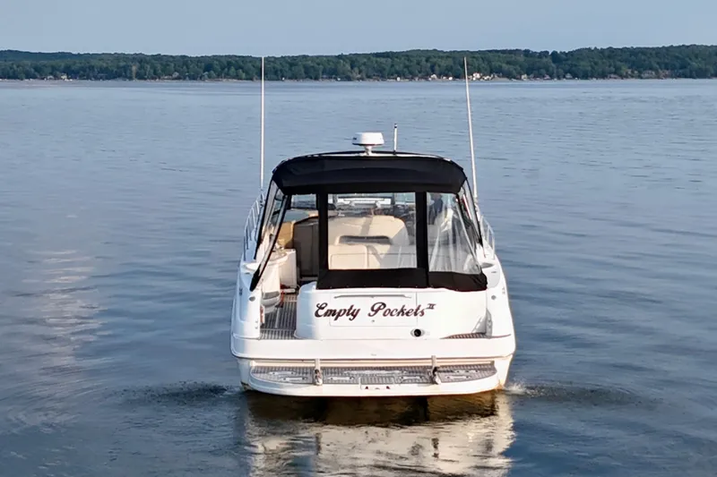 Empty Pockets Yacht Photos Pics 1999 Sea Ray 460 Sundancer yacht named "Empty Pockets" on calm lake waters.