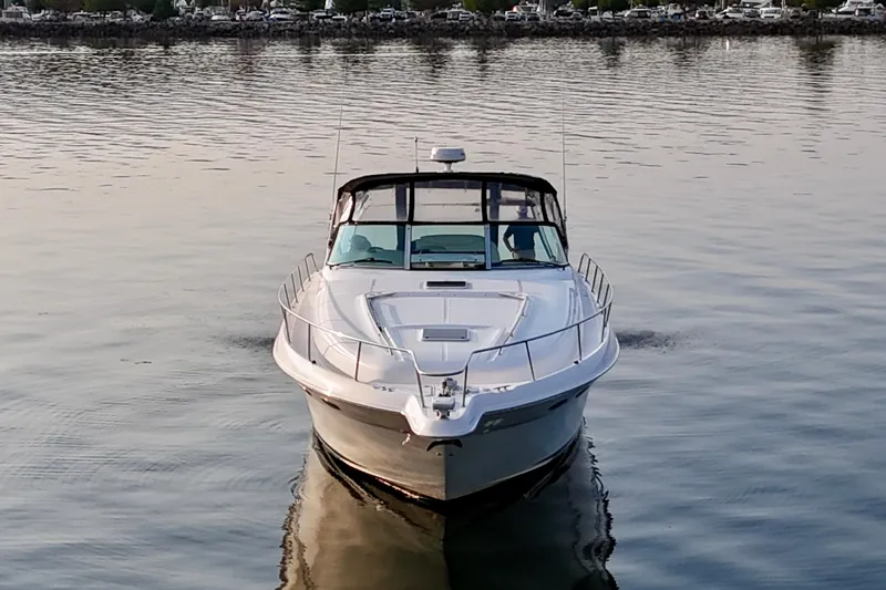 Empty Pockets Yacht Photos Pics 1999 Sea Ray 460 Sundancer yacht cruising on calm waters at sunset.