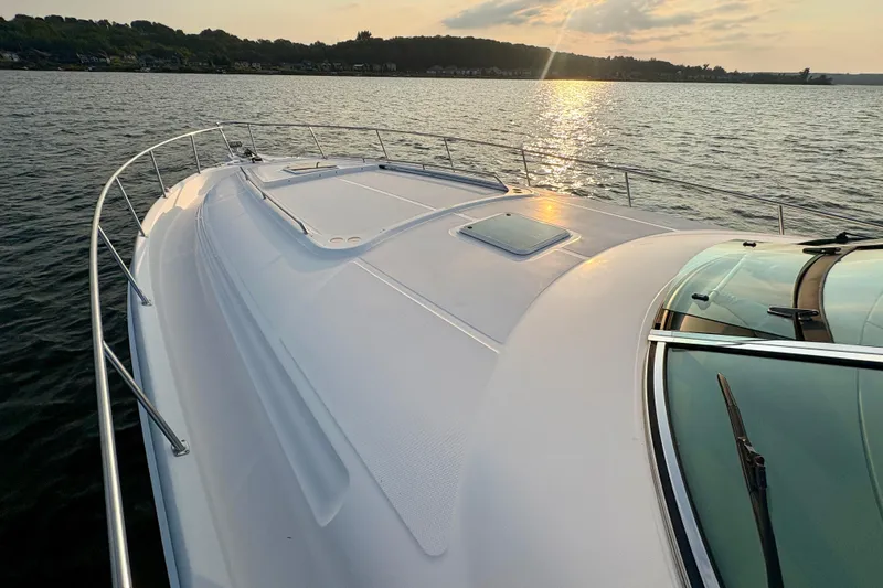 Empty Pockets Yacht Photos Pics 1999 Sea Ray 460 Sundancer yacht on calm water at sunset.