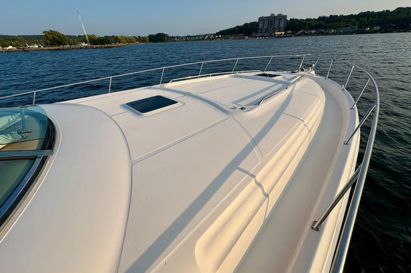 Empty Pockets Yacht Photos Pics 1999 Sea Ray 460 Sundancer yacht on calm water, showcasing sleek deck design.