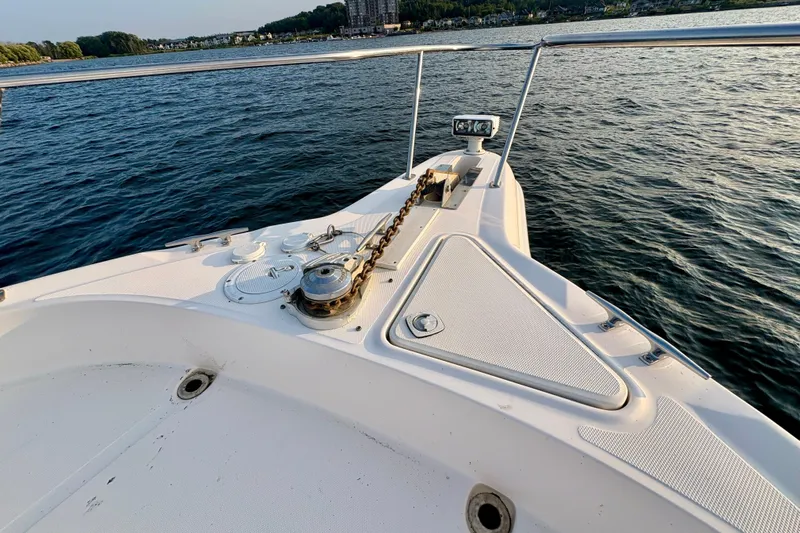 Empty Pockets Yacht Photos Pics Bow of 1999 Sea Ray 460 Sundancer yacht on calm water, featuring anchor and railing.