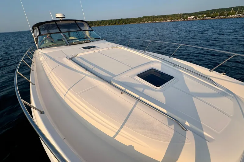 Empty Pockets Yacht Photos Pics 1999 Sea Ray 460 Sundancer yacht on calm water, showcasing sleek deck design.