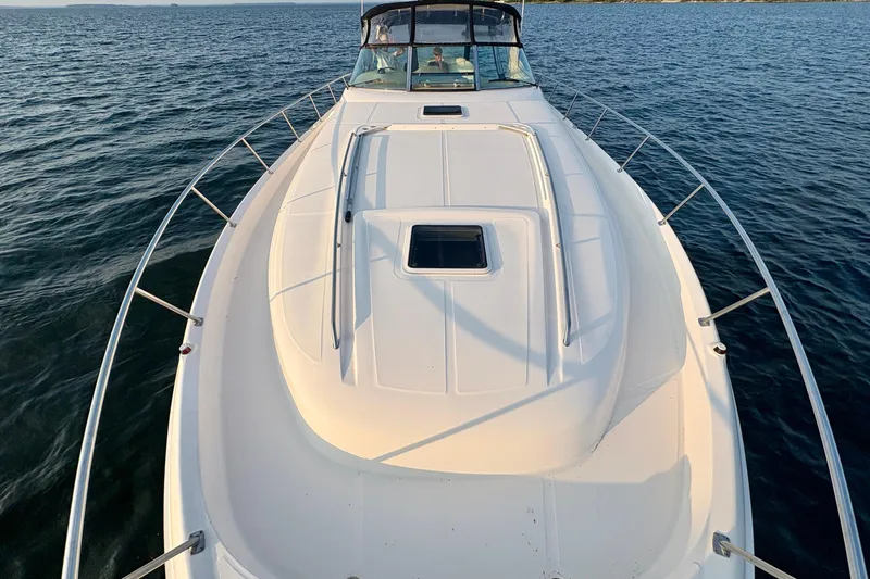 Empty Pockets Yacht Photos Pics 1999 Sea Ray 460 Sundancer yacht on open water, showcasing sleek deck design.