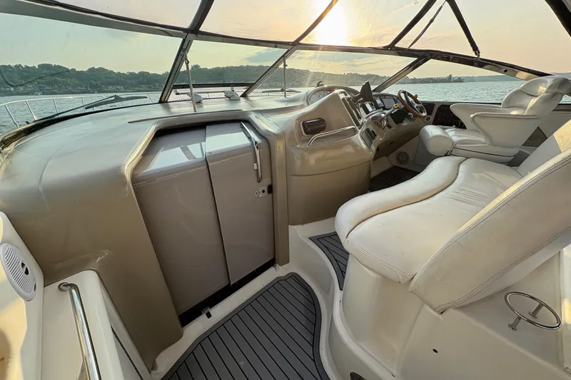 Empty Pockets Yacht Photos Pics 1999 Sea Ray 460 Sundancer cockpit with luxurious seating and scenic sunset view.