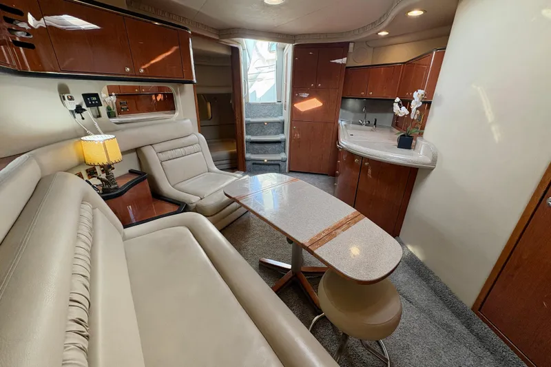 Empty Pockets Yacht Photos Pics Luxurious interior of a 1999 Sea Ray 460 Sundancer yacht with elegant seating and cabinetry.