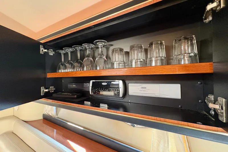 Empty Pockets Yacht Photos Pics Cabinet in 1999 Sea Ray 460 Sundancer yacht with glassware and audio equipment.