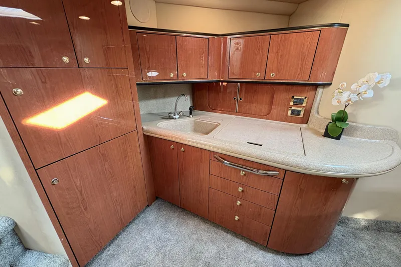 Empty Pockets Yacht Photos Pics Luxurious 1999 Sea Ray 460 Sundancer yacht interior with elegant wood cabinetry and modern amenities.