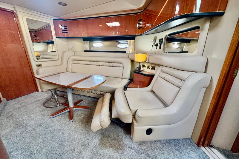 Empty Pockets Yacht Photos Pics Luxurious interior of a 1999 Sea Ray 460 Sundancer yacht with plush seating and elegant wood finishes.