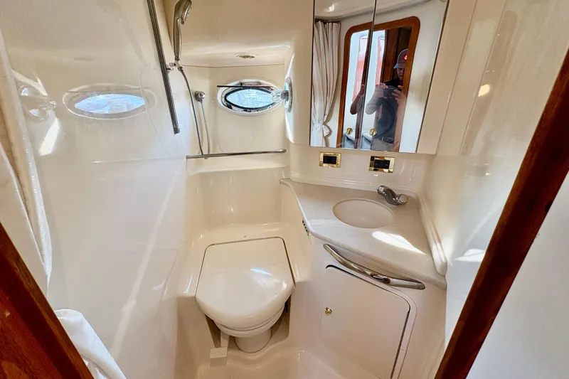Empty Pockets Yacht Photos Pics Bathroom interior of 1999 Sea Ray 460 Sundancer yacht, featuring shower, toilet, and sink.