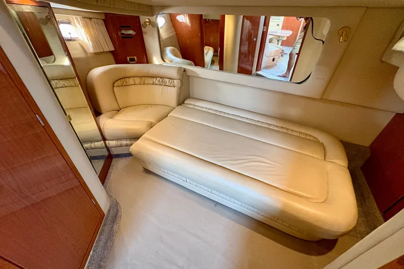 Empty Pockets Yacht Photos Pics Luxurious interior of 1999 Sea Ray 460 Sundancer yacht with beige seating and mirrors.