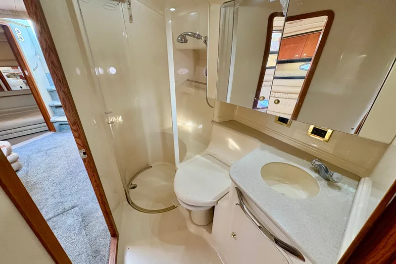 Empty Pockets Yacht Photos Pics 1999 Sea Ray 460 Sundancer yacht bathroom with shower, sink, and toilet.