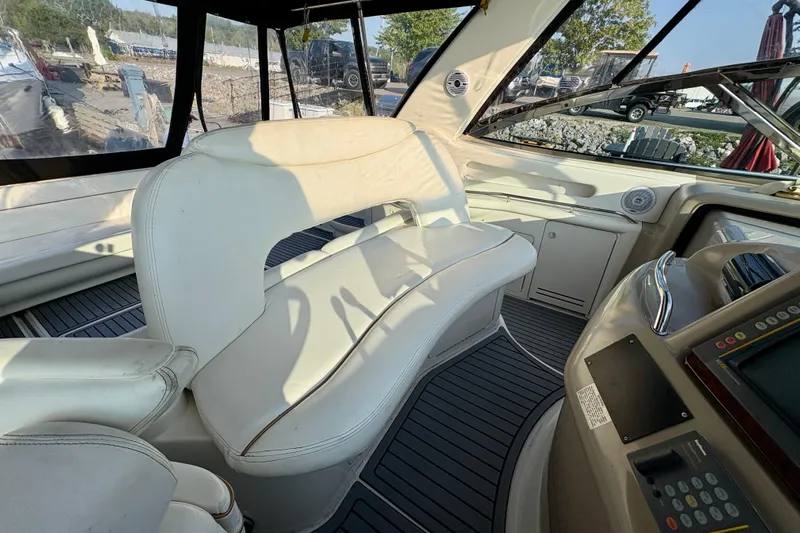 Empty Pockets Yacht Photos Pics Interior of 1999 Sea Ray 460 Sundancer yacht with white seating and control panel.