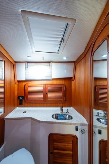 Lionheart Yacht Photos Pics Luxurious 2008 Hinckley Talaria 44 FB yacht bathroom with wood accents and modern fixtures.