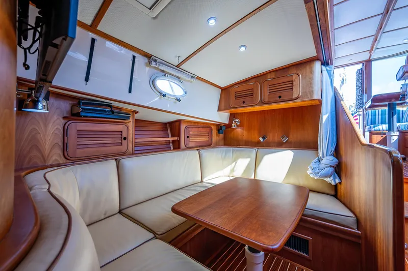 Lionheart Yacht Photos Pics Luxurious interior of 2008 Hinckley Talaria 44 FB yacht with wood finish and seating area.